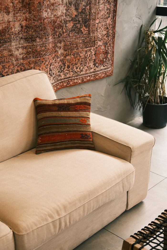Cream sofa with a patterned cushion